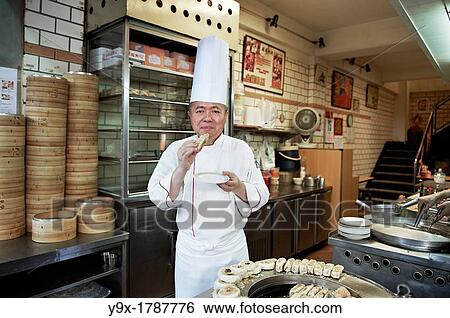 Head Chef Huang Lai Fa of The Grand Formosa Regent Hotel Taipei, posing and sampling food on Yongkang Street in Taipei, Taiwan View Large Photo Image Stock Photograph - Head Chef Huang Lai Fa of The Grand Formosa Regent Hotel Taipei, posing and sampling food on Yongkang Street in Taipei, Taiwan. Fotosearch