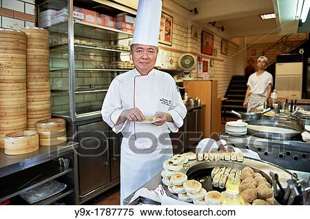 Head Chef Huang Lai Fa of The Grand Formosa Regent Hotel Taipei, posing and sampling food on Yongkang Street in Taipei, Taiwan View Large Photo Image Stock Photography - Head Chef Huang Lai Fa of The Grand Formosa Regent Hotel Taipei, posing and sampling food on Yongkang Street in Taipei, Taiwan. Fotosearch