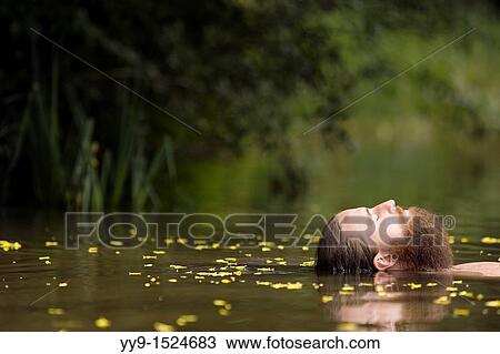 Stock Image - Head of Bearded Man floating in lake - Cedar Mountain, North Carolina USA. Fotosearch