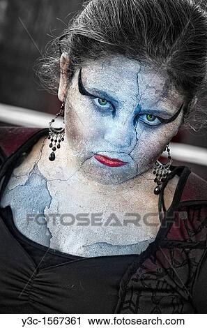 Stock Image - Head of Stone - Young woman in a Halloween costume looking statuesque. Fotosearch