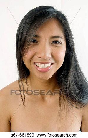 Heads and shoulders portrait of early 20's asian, Chinese woman smiling View Large Photo Image Stock Photo - Heads and shoulders portrait of early 20's asian, Chinese woman smiling. Fotosearch