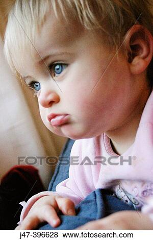 Headshot of 1 year old girl looking off camera, serious View Large Photo Image Stock Photo - Headshot of 1 year old girl looking off camera, serious. Fotosearch