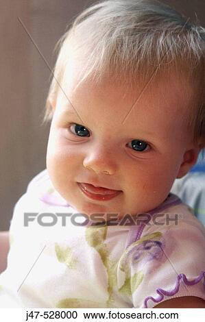 Stock Image - Headshot of a 1, year old girl smiling into camera. Fotosearch