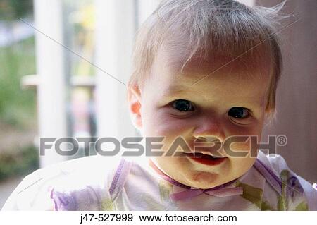 Stock Photo - Headshot of a 1 year old girl smiling into camera. Fotosearch