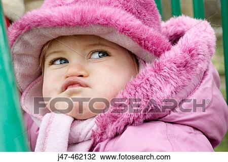 Stock Image - Headshot of a 20 month old girl pulling a funny face. Fotosearch