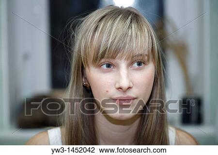 Stock Image - Headshot of a 24 year old blonde Caucasian woman indoors. Fotosearch