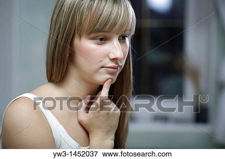 Headshot of a 24 year old blonde Caucasian woman wearing a tank top indoors, thinking View Large Photo Image Stock Photo - Headshot of a 24 year old blonde Caucasian woman wearing a tank top indoors, thinking. Fotosearch