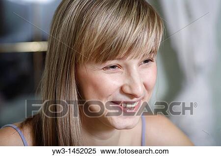 Stock Photography - Headshot of a 24 year old blonde Caucasian woman wearing a tank top indoors. Fotosearch