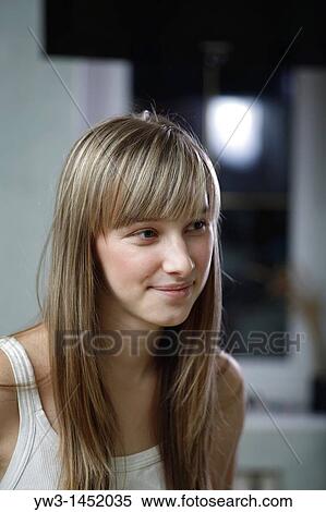 Stock Photography - Headshot of a 24 year old blonde Caucasian woman wearing a tank top indoors. Fotosearch
