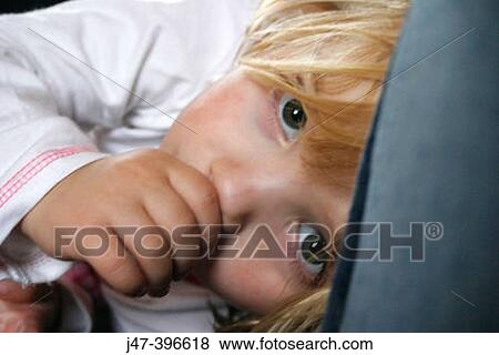 Headshot of a 3 year old girl lying Downucking her thumb, looking into camera View Large Photo Image Stock Photo - Headshot of a 3 year old girl lying Downucking her thumb, looking into camera. Fotosearch