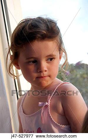 Headshot of a 4 year old girl sitting looking thoughtful View Large Photo Image Stock Photo - Headshot of a 4 year old girl sitting looking thoughtful. Fotosearch