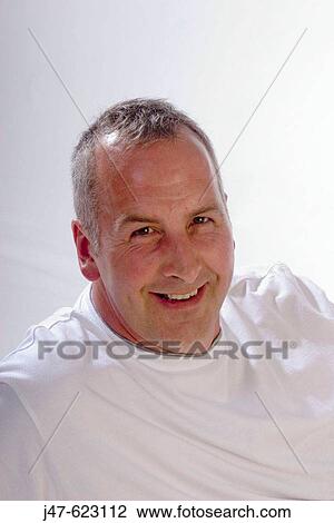 Headshot of a 45 year old man smiling into camera View Large Photo Image Stock Image - Headshot of a 45 year old man smiling into camera. Fotosearch