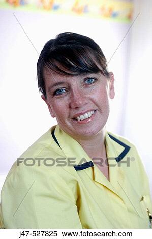 Stock Photography - Headshot of a nursery nurse at work, wearing her uniform. Fotosearch