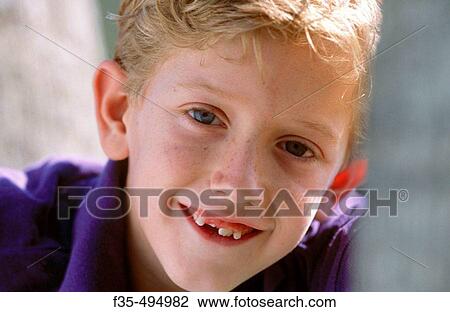 Headshot of Blond boy with lost tooth View Large Photo Image Stock Image - Headshot of Blond boy with lost tooth. Fotosearch