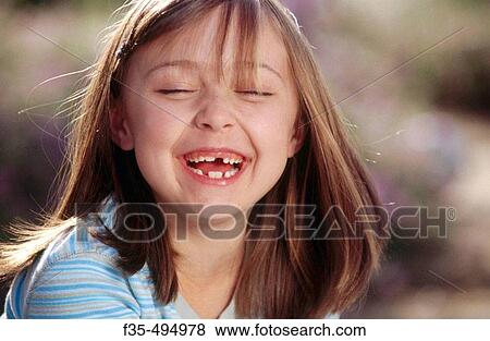 Headshot of Happy Girl with missing teeth laughing View Large Photo Image Stock Photo - Headshot of Happy Girl with missing teeth laughing. Fotosearch