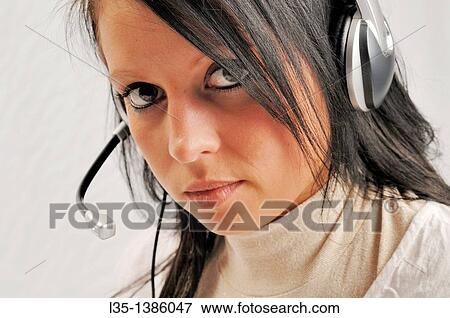 Headtset woman looks into the camera View Large Photo Image Stock Photo - Headtset woman looks into the camera. Fotosearch