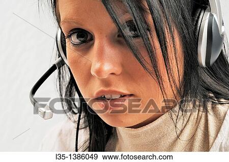 Headtset woman looks into the camera View Large Photo Image Stock Photo - Headtset woman looks into the camera. Fotosearch