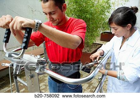 Stock Image - Health and Quality of life Unit researcher developing a mobile walking device, FIK technology research program for aged and disabled people. Fatronik-Tecnalia, Research and Technology Center, Donostia, Basque Country, Spain. Fotosearch