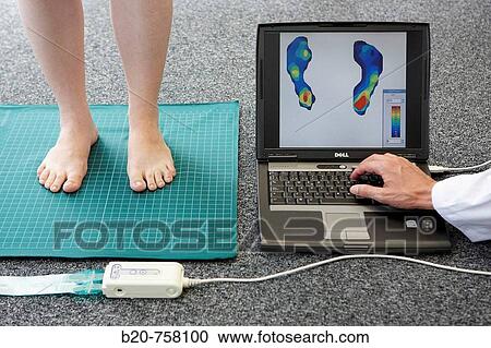 Stock Image - Health and Quality of life Unit researcher monitoring the plantar pressure distribution on the sole of foot, FIK technology research program for aged and disabled people. Fatronik-Tecnalia, Research and Technology Center, Donostia, Basque Country, Spain. Fotosearch