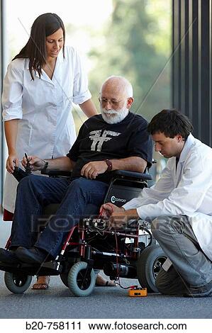 Stock Image - Health and Quality of life Unit researchers developing a control system for intelligent power wheelchair, FIK technology research program for aged and disabled people. Fatronik-Tecnalia, Research and Technology Center, Donostia, Basque Country, Spain. Fotosearch