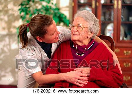 Health care worker giving support to resident in nursing home View Large Photo Image Stock Photograph - Health care worker giving support to resident in nursing home. Fotosearch