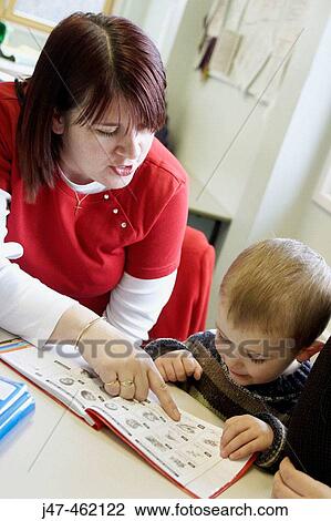 health visitor showing 3 year old boy a book View Large Photo Image Stock Image - health visitor showing 3 year old boy a book. Fotosearch