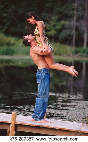 Healthy man lifts his girlfriend View Large Photo Image Stock Photo - Healthy man lifts his girlfriend. Fotosearch