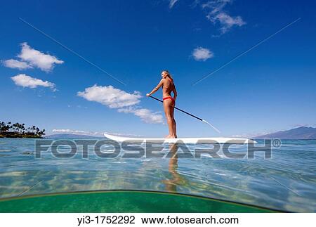 Healthy Maui girl stand-up paddles at Napili Bay, Maui, Hawaii View Large Photo Image Stock Image - Healthy Maui girl stand-up paddles at Napili Bay, Maui, Hawaii. Fotosearch