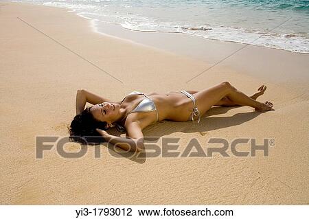 Healthy, sexy woman reclines on the beach at Makena, Maui, Hawaii View Large Photo Image Stock Image - Healthy, sexy woman reclines on the beach at Makena, Maui, Hawaii. Fotosearch