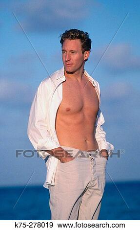 healthy young man at the beach View Large Photo Image Stock Photo - healthy young man at the beach. Fotosearch