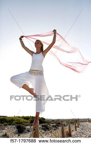 Healthy young woman balancing on a wooden post View Large Photo Image Stock Photo - Healthy young woman balancing on a wooden post. Fotosearch
