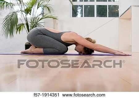 Healthy young woman doing the child's pose yoga position View Large Photo Image Stock Image - Healthy young woman doing the child's pose yoga position. Fotosearch