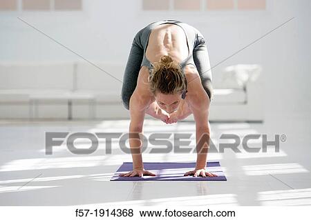 Healthy young woman doing the crane pose yoga position View Large Photo Image Stock Photo - Healthy young woman doing the crane pose yoga position. Fotosearch