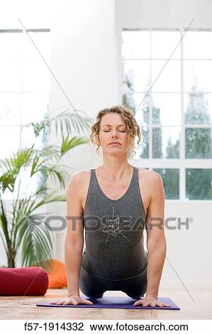 Healthy young woman doing the upward-facing dog yoga position View Large Photo Image Stock Image - Healthy young woman doing the upward-facing dog yoga position. Fotosearch
