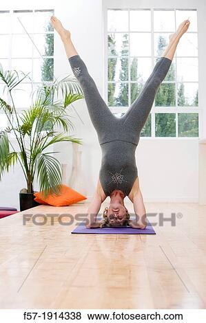 Healthy young woman doing the supported headstand yoga position View Large Photo Image Stock Photo - Healthy young woman doing the supported headstand yoga position. Fotosearch