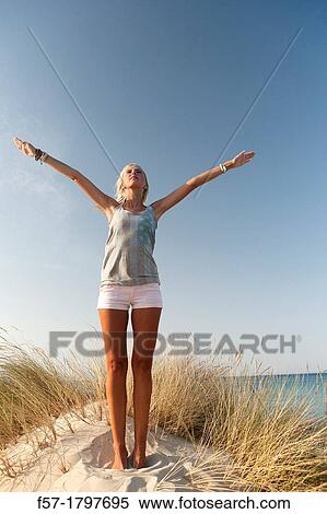 Healthy young woman in the dunes exercising View Large Photo Image Stock Photography - Healthy young woman in the dunes exercising. Fotosearch