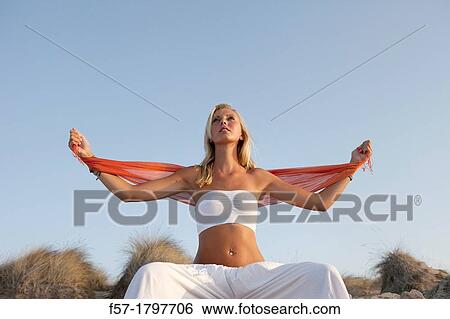 Healthy young woman meditating on the beach View Large Photo Image Stock Photograph - Healthy young woman meditating on the beach. Fotosearch