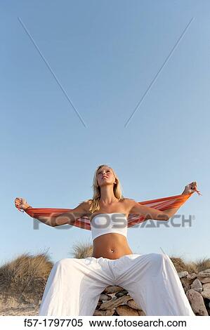 Healthy young woman meditating on the beach View Large Photo Image Stock Photography - Healthy young woman meditating on the beach. Fotosearch
