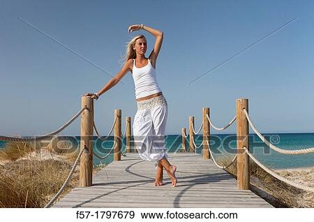 Healthy young woman on a boardwalk View Large Photo Image Stock Photo - Healthy young woman on a boardwalk. Fotosearch