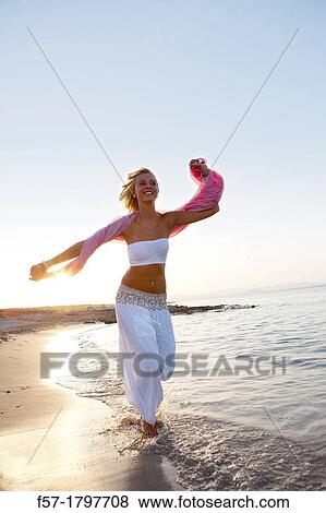 Healthy young woman running at the beach View Large Photo Image Stock Photo - Healthy young woman running at the beach. Fotosearch