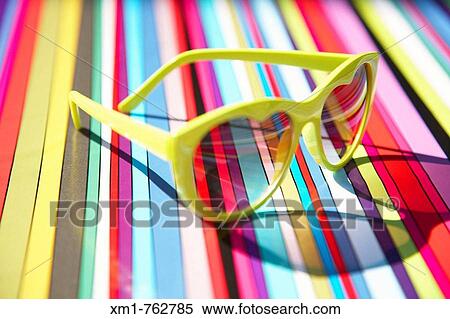 Heart shaped sunglasses on a multi coloured stripey background View Large Photo Image Stock Photography - Heart shaped sunglasses on a multi coloured stripey background. Fotosearch
