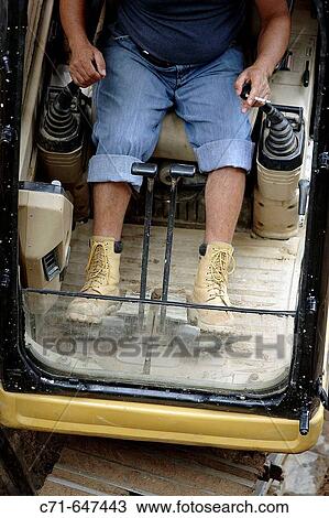 Heavy construction equipment operator working controls View Large Photo Image Stock Image - Heavy construction equipment operator working controls. Fotosearch
