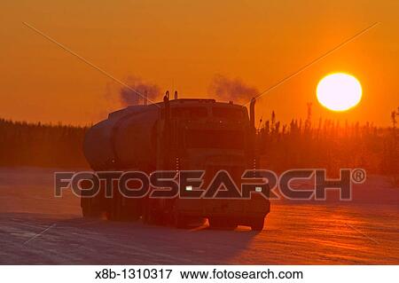 Stock Photo - Heavy trucks on the ice road from Tibbitt to Contwoyto beginning just outside of Yellowknife, Northwest Territories, Canada. Fotosearch