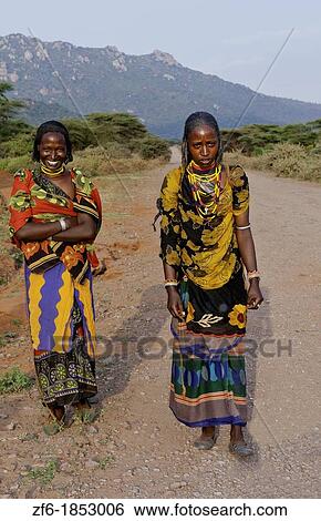 Stock Photograph - Hegrmarian Ethiopia Africa Lower Omo Valley sunset portrait of young Borena tribe girls with colorful outfits in open reserve 29. Fotosearch