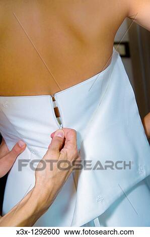 Help in zipping up the wedding dress View Large Photo Image Stock Image - Help in zipping up the wedding dress. Fotosearch