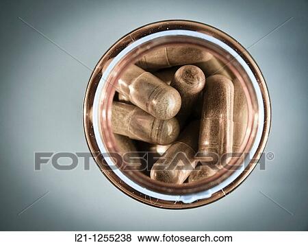 Herbal pills in a glass container View Large Photo Image Stock Photo - Herbal pills in a glass container. Fotosearch