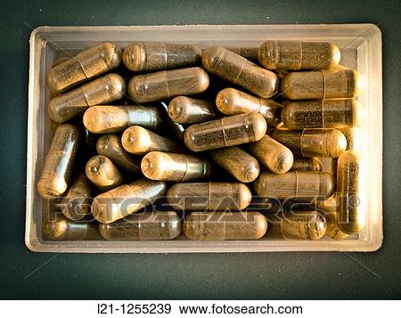 Stock Photo - Herbal pills in a plastic box. Fotosearch