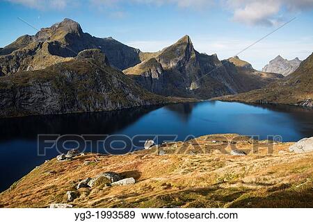 Stock Photo - Hermannsdalstinden mountain peak left in Autumn, Moskenesoya, Lofoten Islands, Norway. Fotosearch