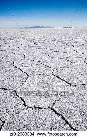 Hexagonal shaped salt flats, polygonal lines of raised salt created from evaporation in dry season, Salar de Uyuni, Bolivia, South America. View Large Photo Image Picture - Hexagonal shaped salt flats, polygonal lines of raised salt created from evaporation in dry season, Salar de Uyuni, Bolivia, South America.. Fotosearch