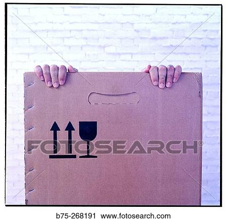 Stock Image - Hiding inside a cardboard box. Fotosearch